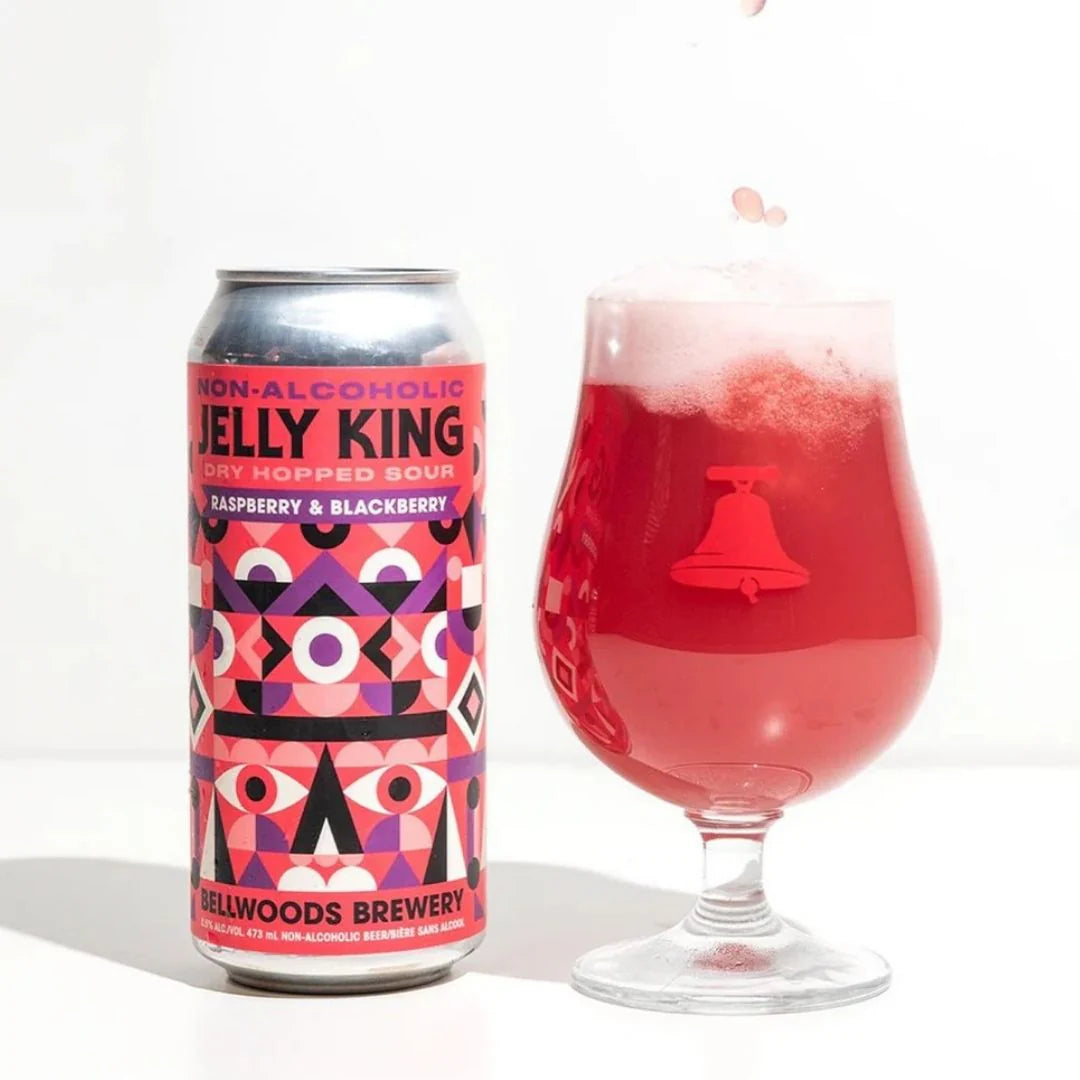 Non-alcoholic raspberry and blackberry jelly king can and glass with a white background