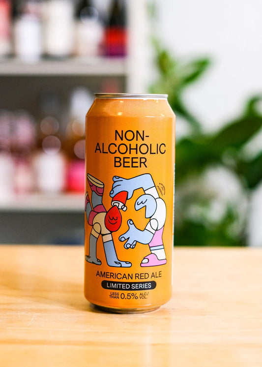 Can of non-alcoholic beer with cartoon characters on a wooden surface