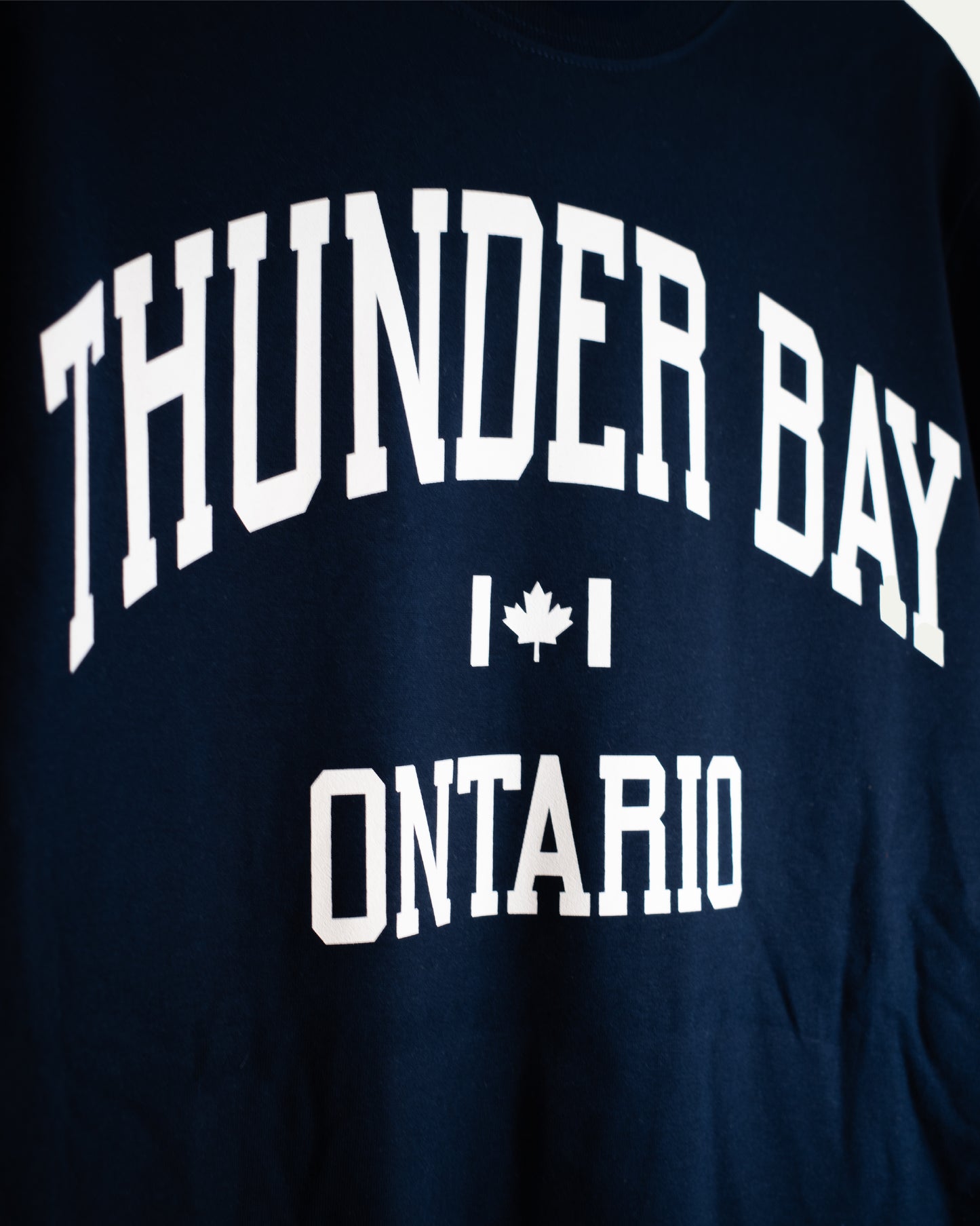 Navy blue shirt with 'Thunder Bay Ontario' text and a maple leaf on a white background