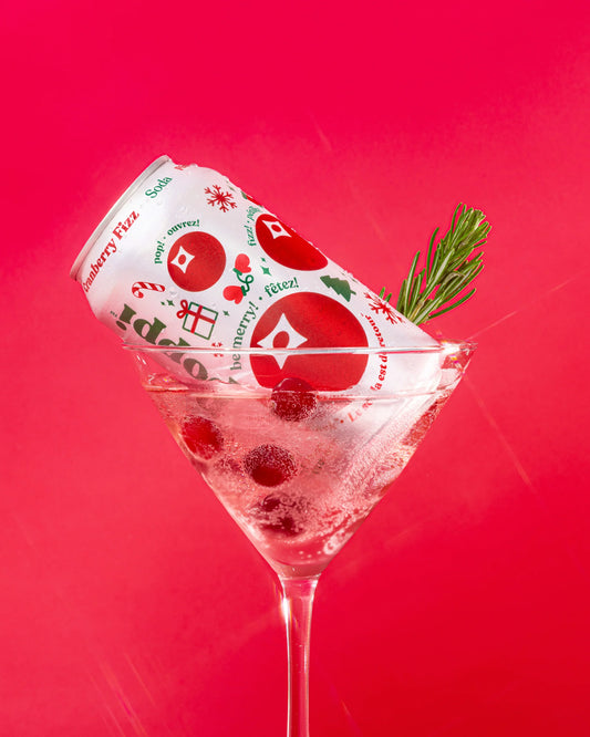 Cocktail with a can of Cranberry Fizz on a red background